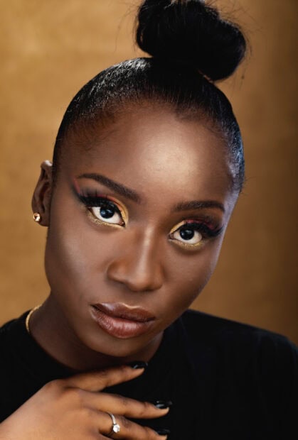 Close up of woman with colorful eye makeup and flawless skin makeup
