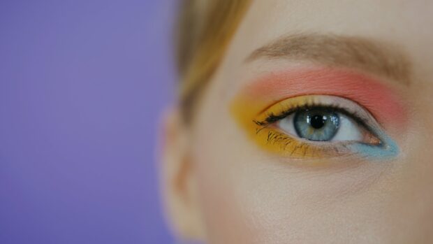 Close up of eye makeup with colorful eyeshadow on blue eye