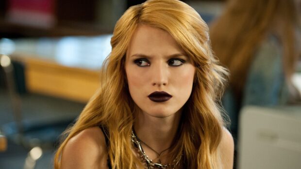 Woman with dark lipstick and smoky eye makeup wearing silver necklace