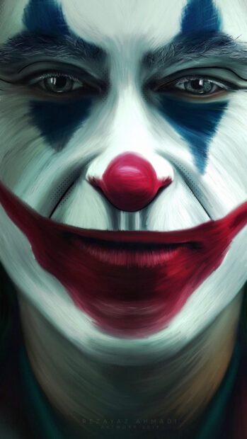 Close up of clown makeup with red nose and blue eye details on face