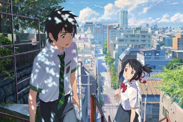 A high school boy and girl walking outside in a city scene from Makoto Shinkai