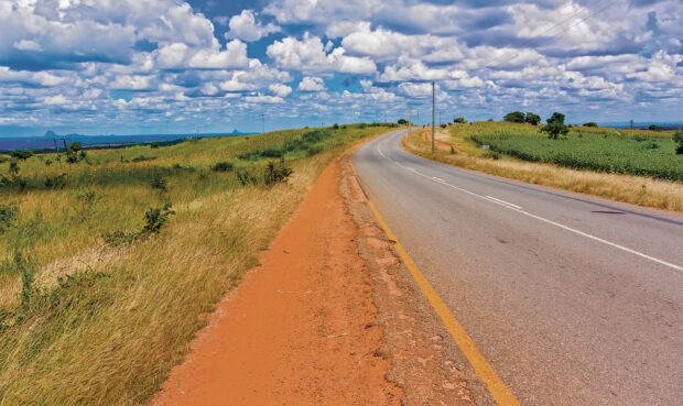 A scenic open road under a cloudy blue sky in Malawi captured in Malawi Wallpapers, 2K Desktop Wallpaper