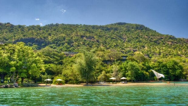 A scenic view of Malawi with a lush green mountain and clear water lake, HD Desktop Wallpaper