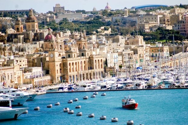 Historic Malta cityscape with boats docked along the vibrant harbor in Malta