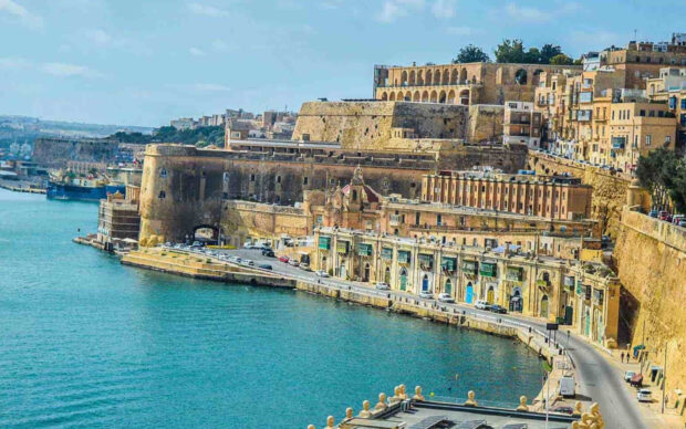Historic architecture and coastline of Malta with ancient stone buildings along the sea