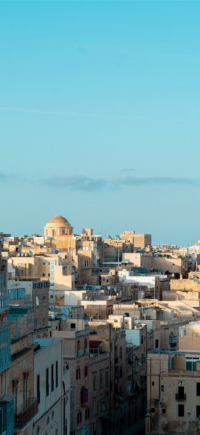 Ancient architecture of Malta with a dome building under a clear blue sky