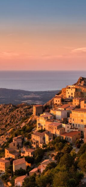 Scenic view of Malta village overlooking the sea during sunset