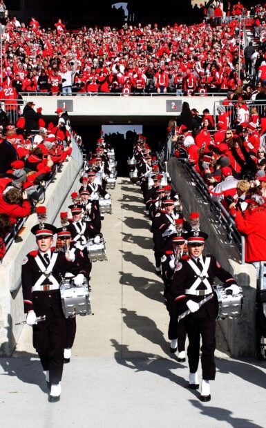 A marching band is performing while the audience watches in a large stadium, HD Mobile Wallpaper