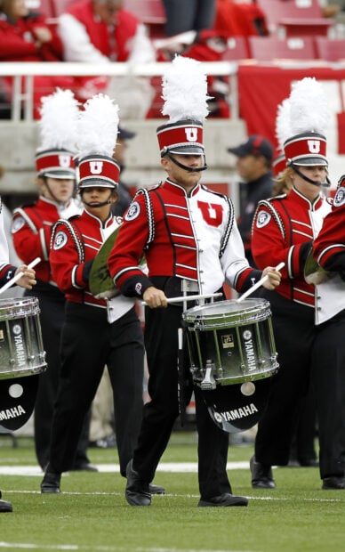 A marching band performs with drums and uniforms on the football field, HD Mobile Wallpaper