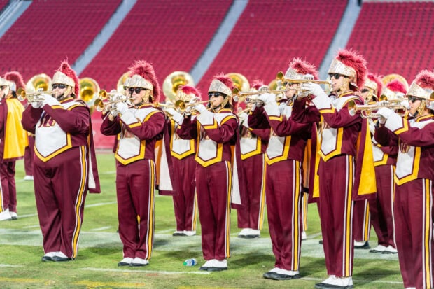 A marching band playing brass instruments on a football field during a performance, 2K Desktop Wallpaper