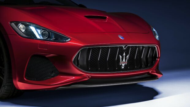 Close up of Maserati red car front grille and headlight detail