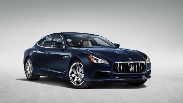 Dark blue Maserati luxury car parked on a plain background with visible Maserati logo