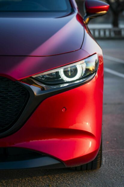 A Mazda shows its detailed front headlight design in red color, HD Mobile Wallpaper