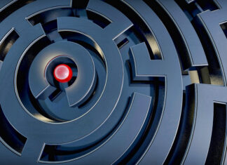 A close up of a circular maze with a red sphere at the center highlighting the maze design