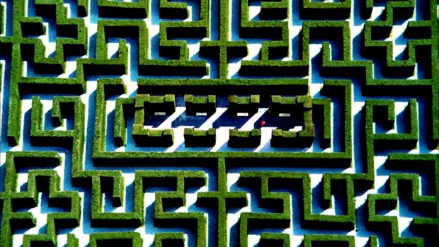 Aerial view of a green hedge maze with clear pathways and complex pattern
