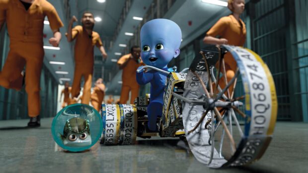 Megamind character riding a custom tricycle in a prison hallway with inmates chasing behind