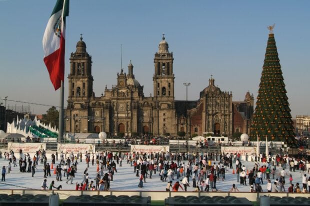 A large crowd enjoys ice skating near a decorated tree in Mexico City during winter, HD Desktop Wallpaper