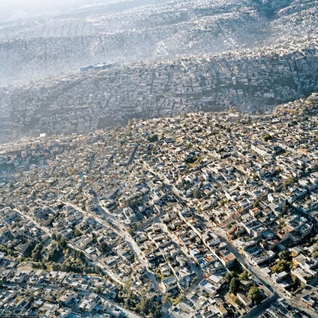 This aerial view showcases the vast urban landscape of Mexico City with densely packed buildings and streets, HD Desktop Wallpaper