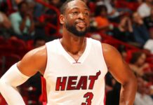 Dwyane Wade smiling on the court in a Miami Heat jersey during a game