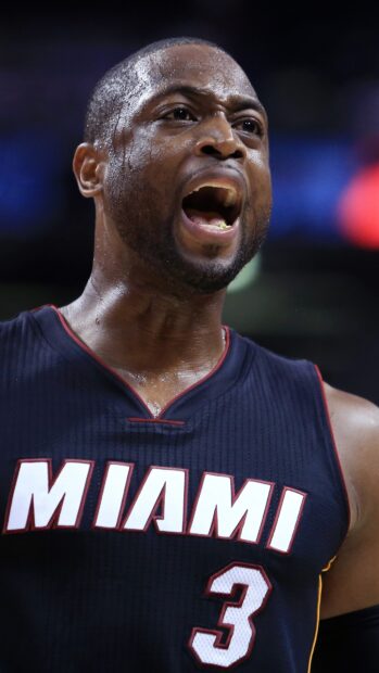Miami Heat player wearing number 3 jersey shouting passionately during a game