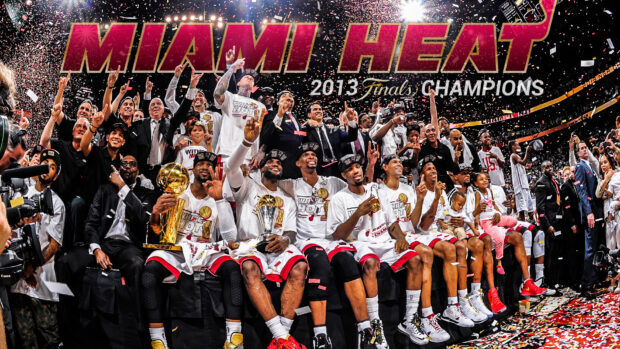 Miami Heat players celebrating their 2013 championship win with trophies and confetti on court