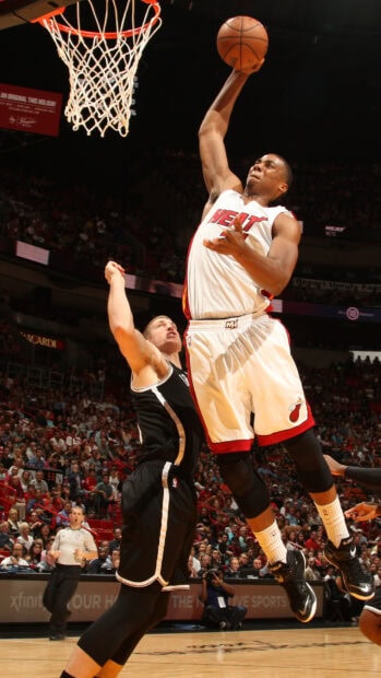 Miami Heat player jumping to score during basketball game in an arena