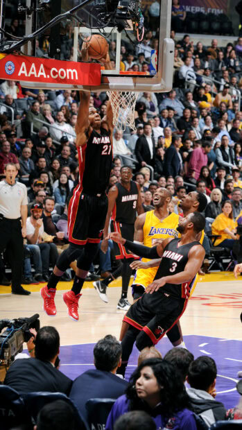Miami player number 21 dunking the basketball during a game against the Lakers