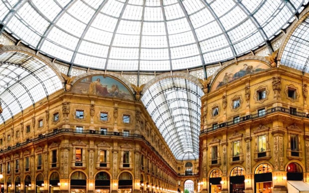 Interior view of Milan shopping gallery with glass roof and historic architecture details
