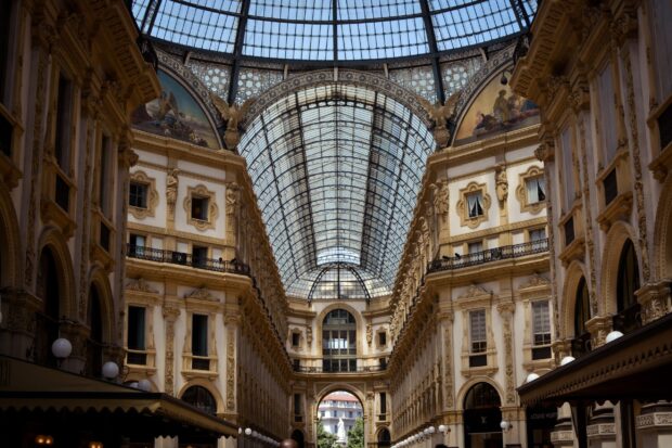 The Milan interior showcases elegant architecture with decorative arches and a glass ceiling