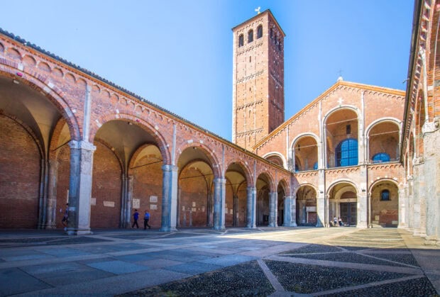 The famous Milan architecture with arches and tower under clear blue sky