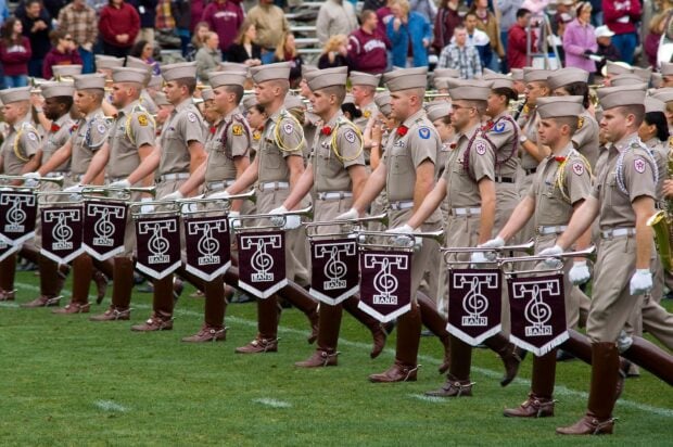 A marching band performs in uniform at a stadium event, 2K Desktop Wallpaper