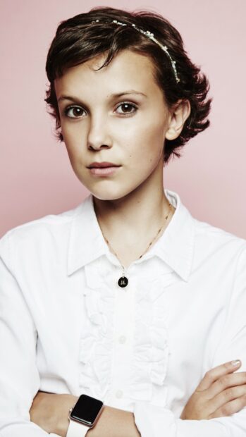 Millie Bobby Brown looks directly at the camera with a serious expression, 4K Phone Wallpaper