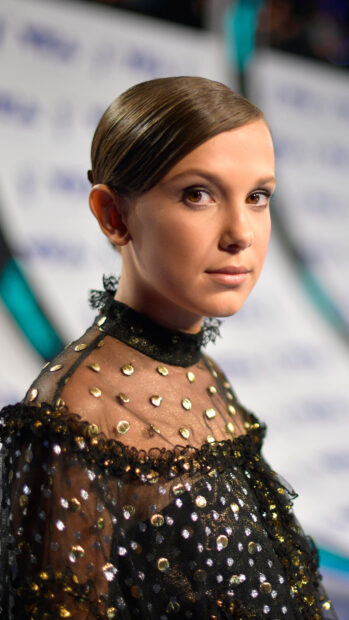 Millie Bobby Brown wallpapers features a close up portrait of the actress in elegant black dress, 4K Mobile Wallpaper