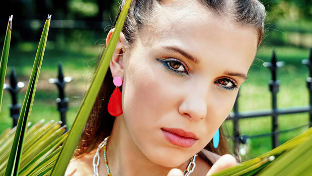 Millie Bobby Brown looks directly into the camera with a serious expression outdoors, 4K Desktop Wallpaper
