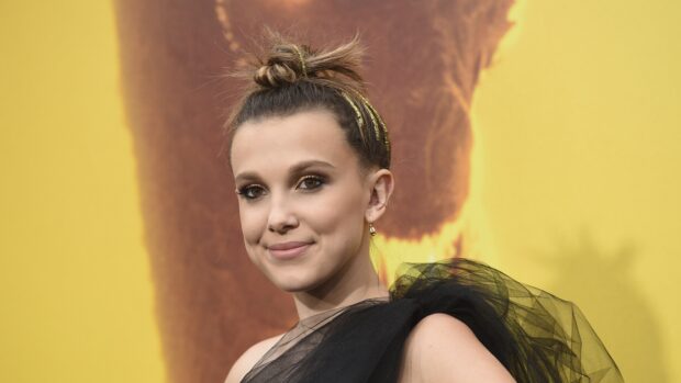 Millie Bobby Brown smiles wearing a black tulle dress at an event, 4K Desktop Wallpaper