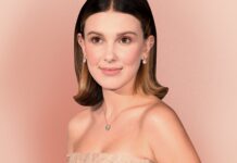 Millie Bobby Brown wears elegant jewelry and a strapless dress against a pink backdrop, 2K Desktop Wallpaper