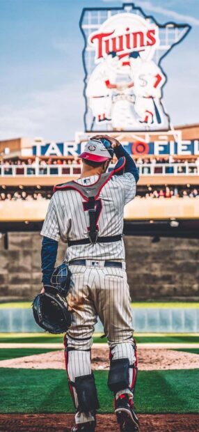 A catcher in pinstriped uniform stands on the field at Target Field with the Twins logo in the background, HD Phone Wallpaper