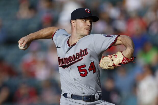 A Minnesota Twins player is pitching during a baseball game, 2K Desktop Wallpaper