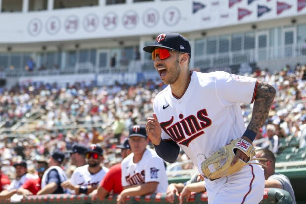 A Minnesota Twins player is celebrating during a game with fans in the background, 2K Desktop Wallpaper