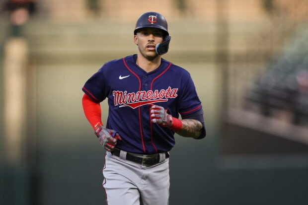 A Minnesota Twins player is running during a baseball game wearing a navy blue jersey, 2K Desktop Wallpaper