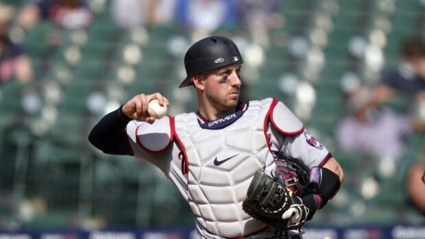 A Minnesota Twins player in full gear is throwing a baseball during a game, 4K Desktop Wallpaper