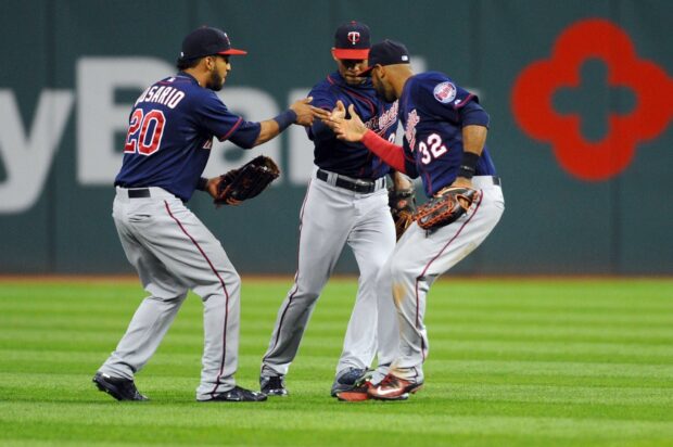 Three Minnesota Twins players celebrate during a game, HD Desktop Wallpaper