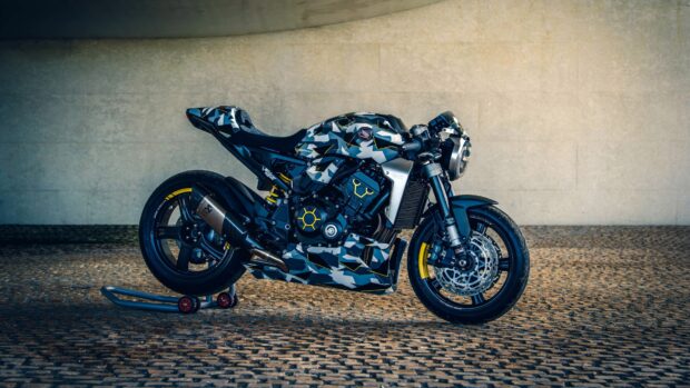 A modern Honda CB1000R bike with a unique camouflage design is parked on a cobblestone floor, 4K Desktop Wallpaper