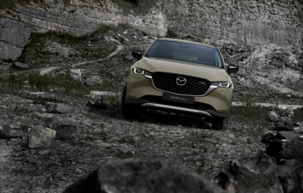 A Mazda CX 5 drives smoothly over rocky terrain under natural light, HD Desktop Wallpaper