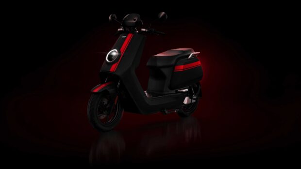 A modern black scooter with red stripes under soft lighting, 4K Desktop Wallpaper