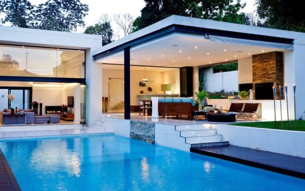 The modern bungalow features an outdoor pool and spacious open living area with stylish décor