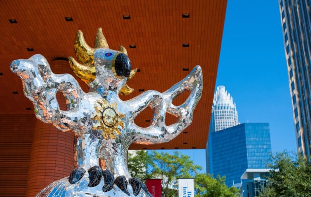 A close up of a modern mosaic sculpture in Charlotte North Carolina with skyscrapers in the background, 2K Desktop Wallpaper
