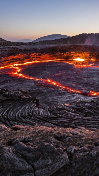 The glowing molten lava flow creates a striking natural landscape in Ethiopia during sunset, HD Phone Wallpaper