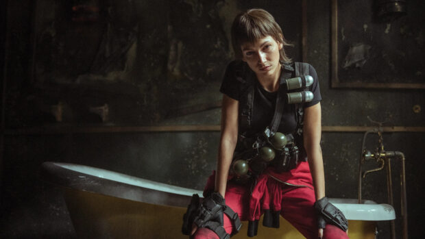 A Money Heist character wearing tactical gear while sitting on a tub in a dark room, HD Desktop Wallpaper