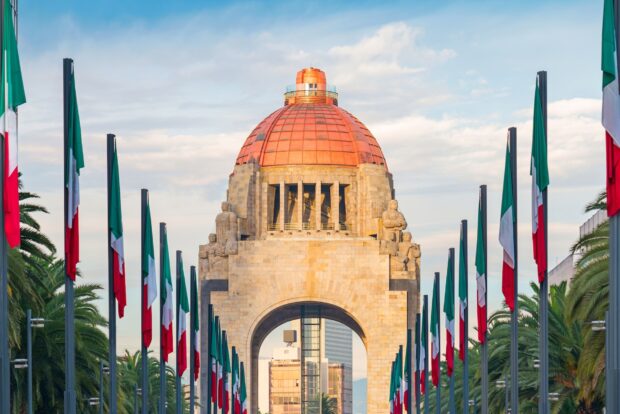 The monument stands tall with Mexican flags along the path in Mexico City, HD Desktop Wallpaper